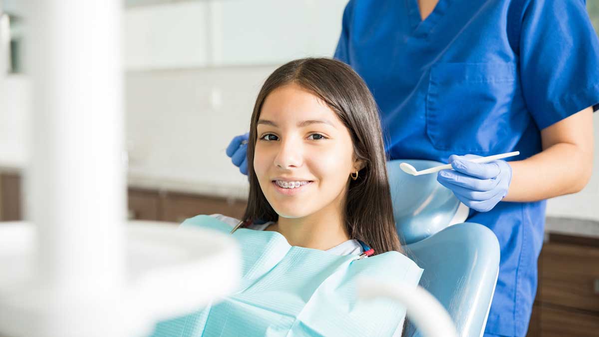 A child wearing orthodontic braces visiting an orthodontist